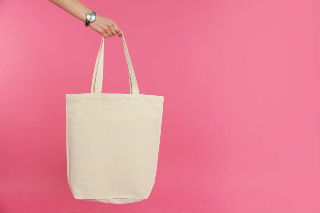 hand holding reusable fabric grocery bag