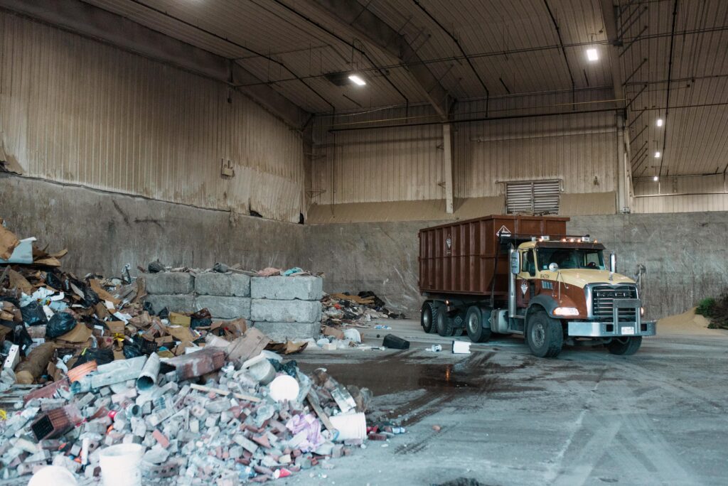 A Miller Waste roll-off truck unloads waste into the transfer station.
