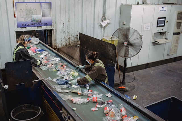 MRF employees manually remove contaminants from PET bottles and containers.